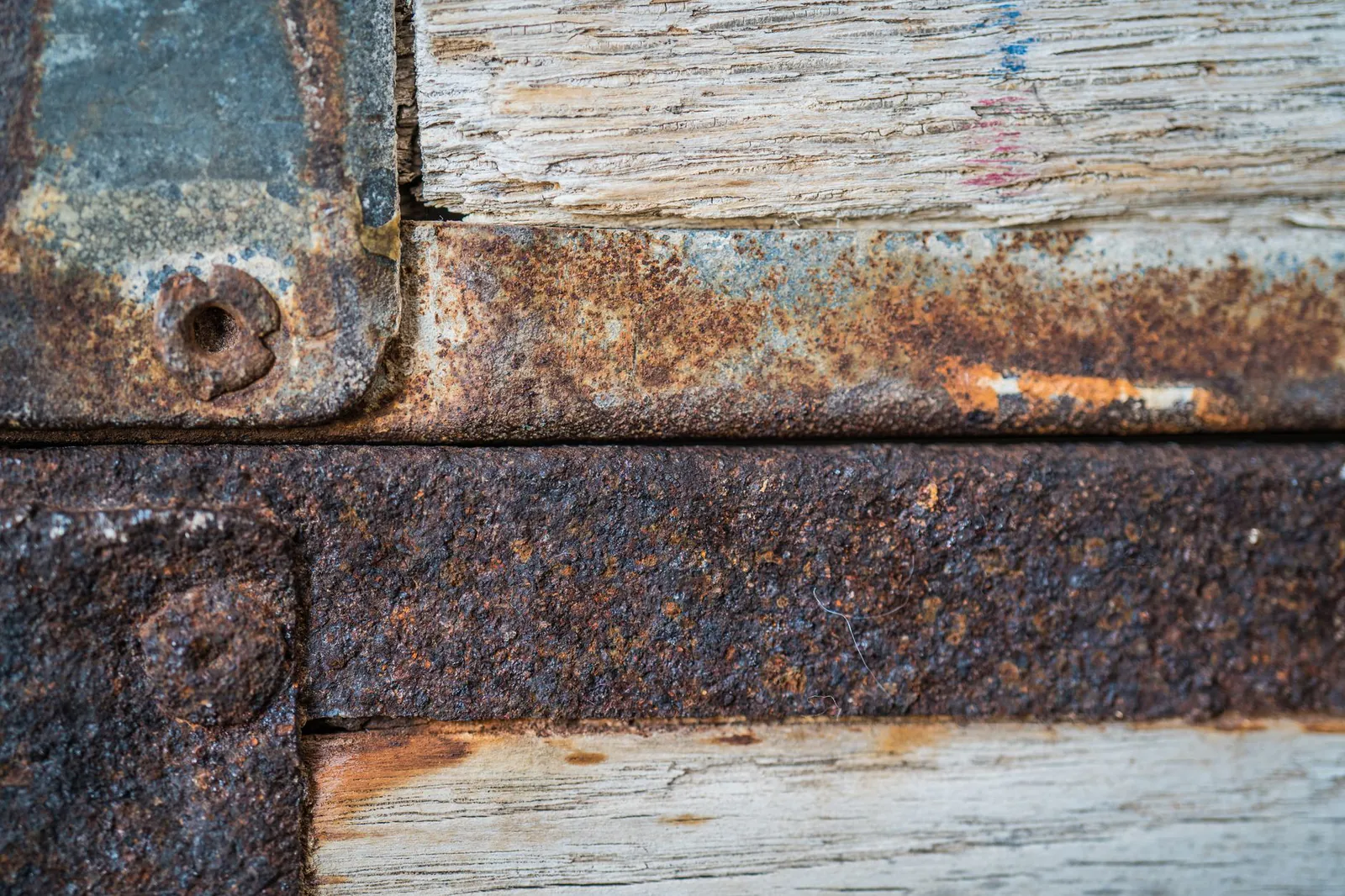 Steel plates and bolts heavily corroded by moisture and wear