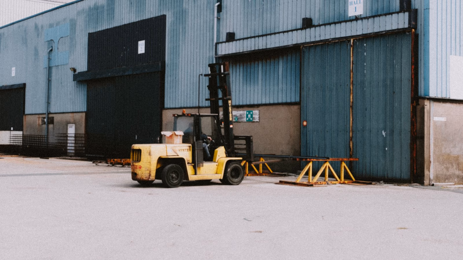 Forklift fitted with industrial wheels outside a factory