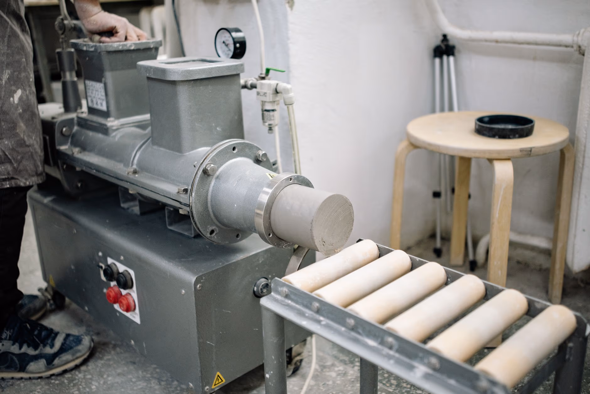 Industrial roller table at the outlet of an extruder in a production shop