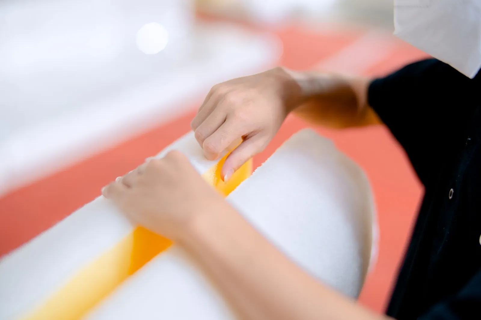 Operator applying a strip of resilient material to a cylindrical part