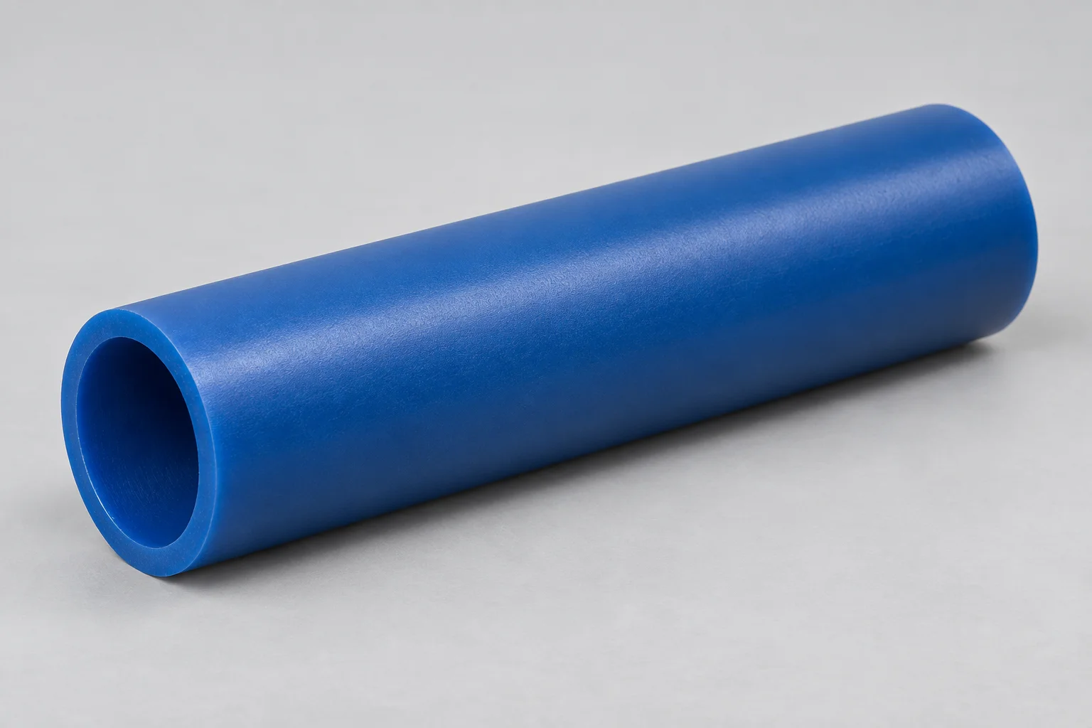 Blue polyurethane roller sleeve, a tubular cover open at both ends, shown on its own